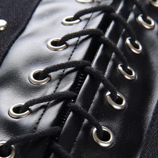 Mandotos black leather lace-up skirt with front lacing detail, fitted style, and high waist, perfect for edgy fashion looks.