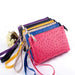 Mandotos chic faux ostrich clutch wristlet in six vibrant shades with zipper pocket, stylish and compact for carrying essentials.