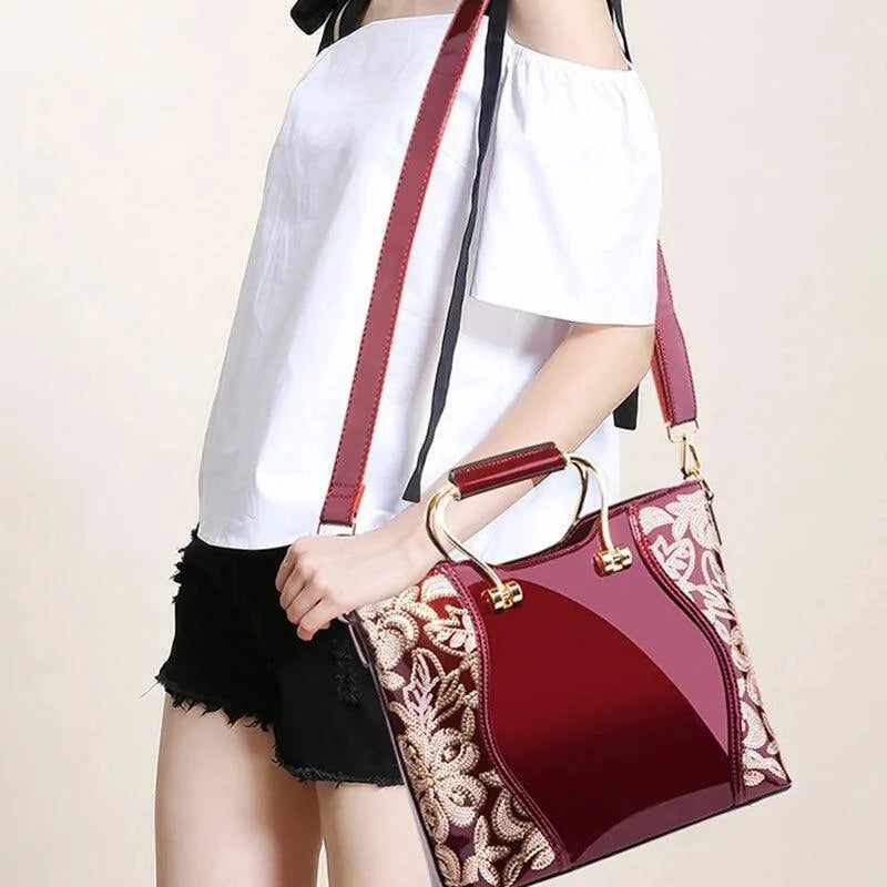 Mandotos burgundy floral leather tote bag with embroidered design and detachable crossbody strap, stylish and elegant for everyday use.
