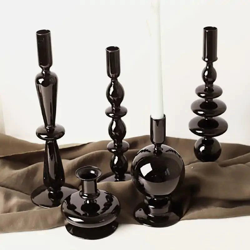 Mandotos Elegant Rue black glass candlestick holder on a table, stylish centerpiece with a sleek, modern design.