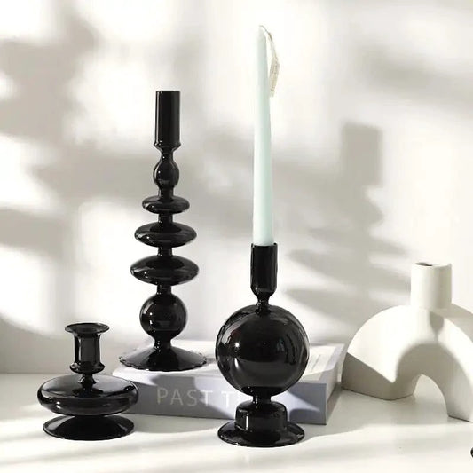 Mandotos Elegant Rue black glass candlestick holder on a table, stylish centerpiece for home decor or gift idea.
