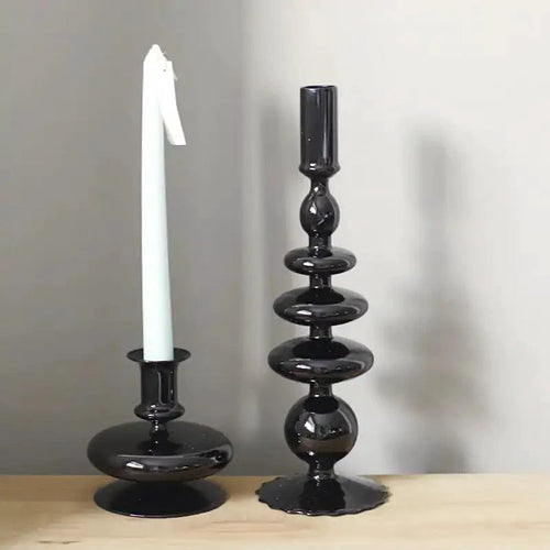 Mandotos Elegant Rue black glass candlestick holder on a table, stylish centerpiece and decor for home or gift ideas.