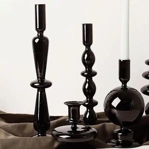 Mandotos Elegant Rue black glass candlestick holder on a table, stylish centerpiece and gift idea for home decor.