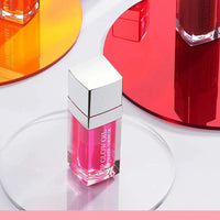 Mandotos moisturizing lip balm oil with plumping and exfoliating lip gloss on a neutral background.
