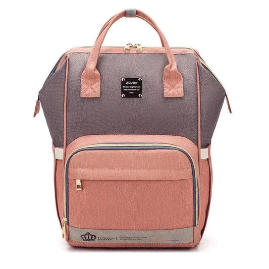 Mandotos Mummy Maternity Bag with multiple compartments, beige fabric, and sturdy handles for expecting mothers.
