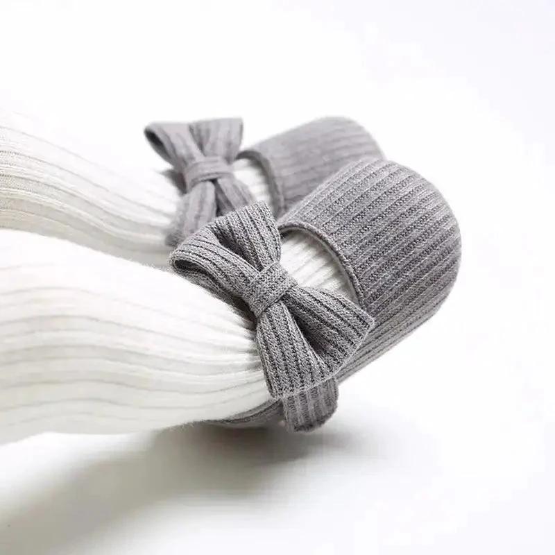 Mandotos newborn soft shoes in pastel colors, featuring soft fabric and gentle sole for comfortable infant wear.