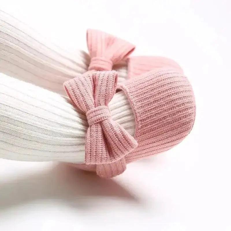 Soft newborn shoes by MANDOTOS, featuring cozy fabric and flexible soles, designed for comfort and gentle support for infants.