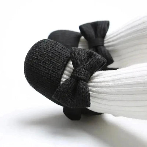 Soft newborn shoes by MANDOTOS, featuring cozy fabric and small, slip-on design perfect for baby’s first steps.
