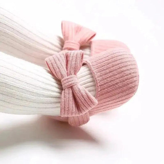 Soft newborn shoes from MANDOTOS, featuring cozy fabric and small, delicate design for infants.