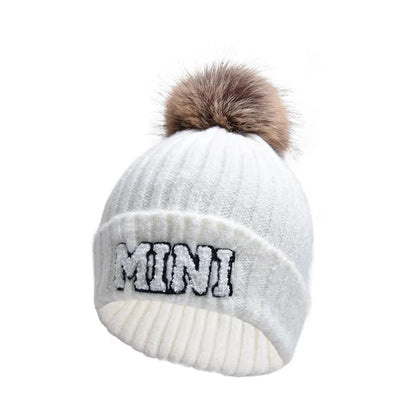 Matching parent-child beanie hats set by MANDOTOS, including three cozy winter knitted caps for mama, papa, and baby.