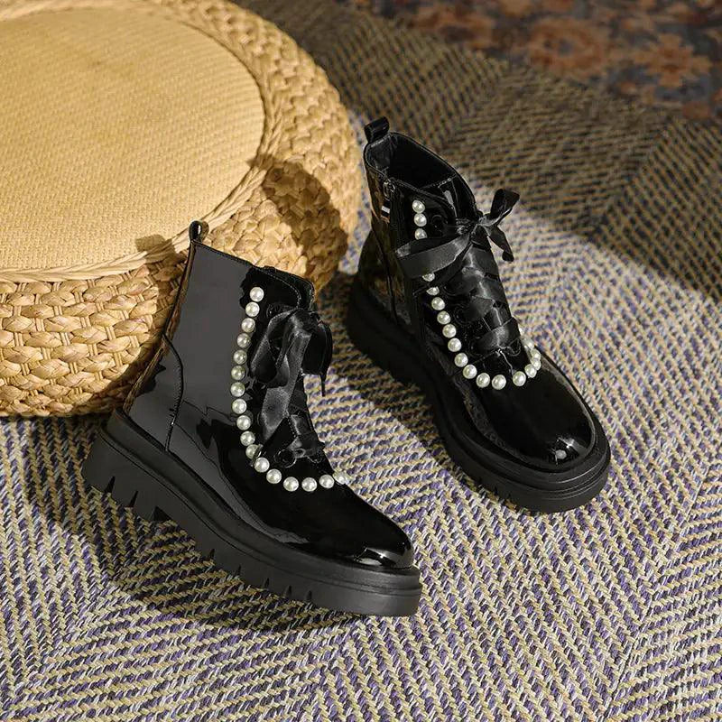Mandotos patent leather ankle boots with sleek design and pointed toes, showcasing shiny black finish and stylish ankle height.