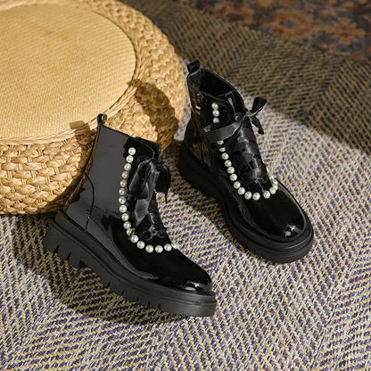 Mandotos patent leather ankle boots with sleek design and pointed toes, showcasing shiny black finish and stylish ankle height.