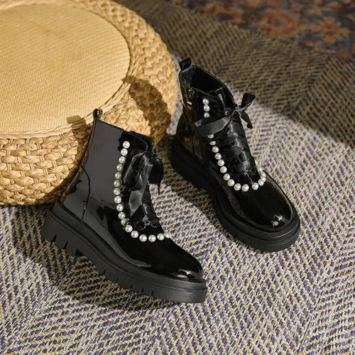 Mandotos patent leather ankle boots with sleek design and pointed toes, showcasing shiny black finish and stylish ankle height.