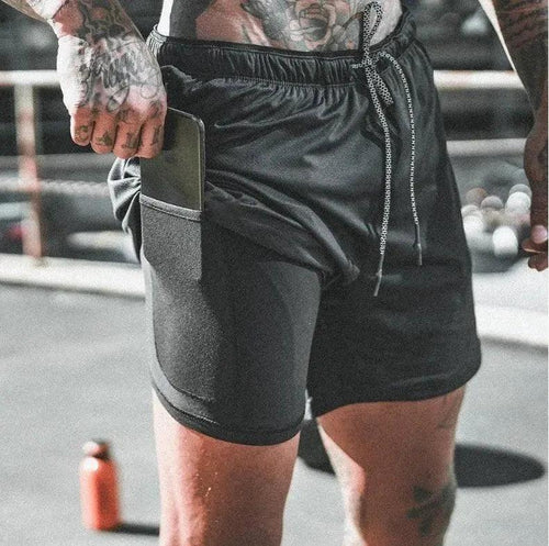 Mandotos pocket compression shorts showing a close-up of black athletic shorts with built-in pocket and elastic waistband for active wear.