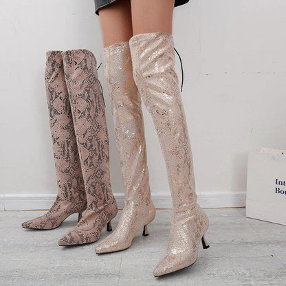 Mandotos pointed over-the-knee high fashion boots showcasing sleek design and tall, fitted silhouette in black leather.