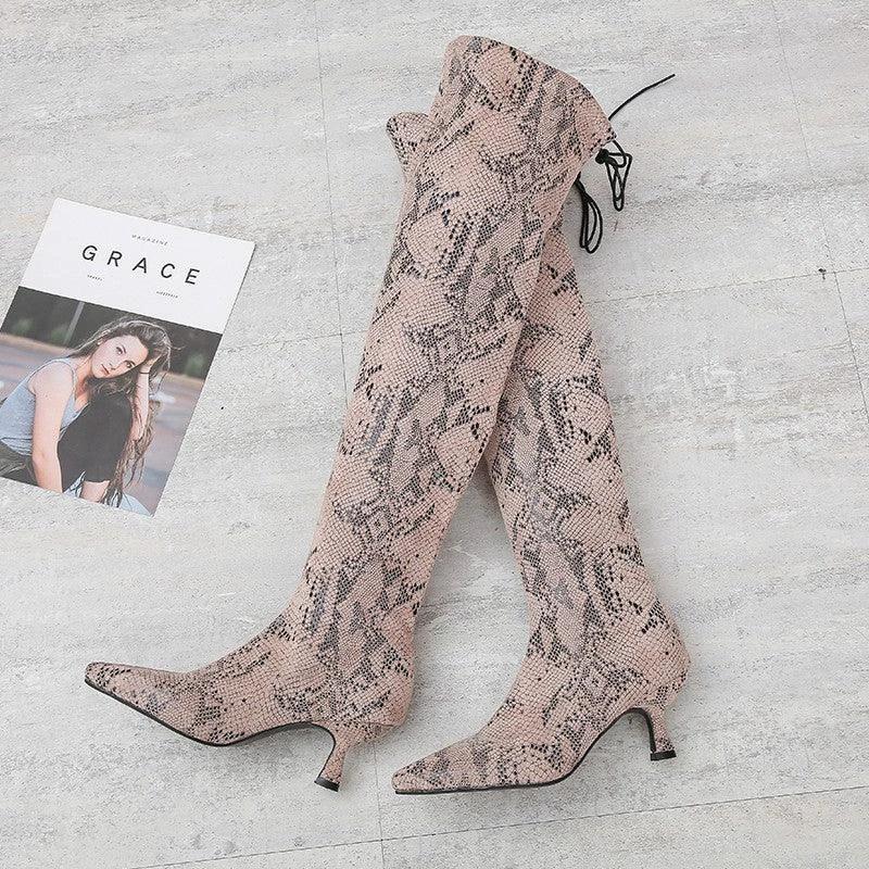 Black pointed over-the-knee high-top fashion boots by MANDOTOS, showcasing sleek design and tall, fitted silhouette.