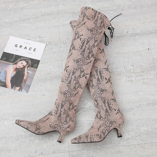 Black pointed over-the-knee high-top fashion boots by MANDOTOS, showcasing sleek design and tall, fitted silhouette.