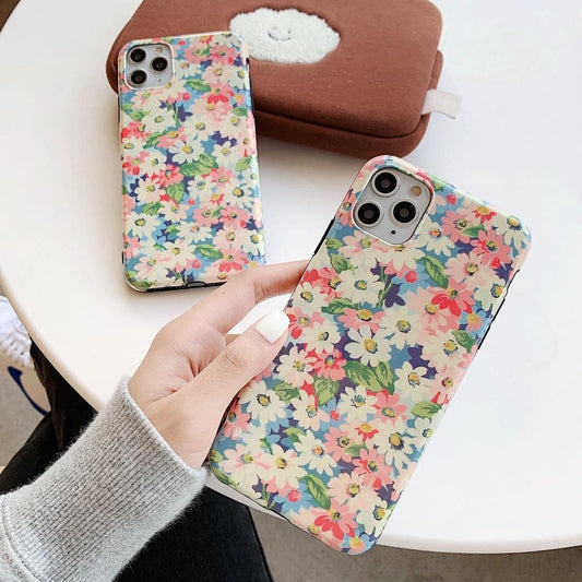 Mandotos retro daisy phone case with colorful floral design on a protective smartphone cover.