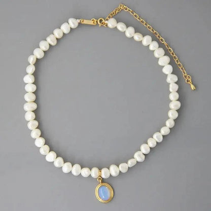 Mandotos round medal pearl necklace with irregular pearls, elegant jewelry piece showcasing a sophisticated design and natural pearl texture.