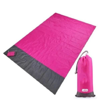 Mandotos sandproof portable beach mat spread out on sandy shore, lightweight and easy to carry for outdoor beach outings.