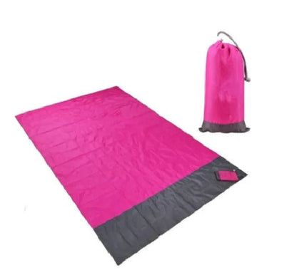 Mandotos sandproof portable beach mat spread on sandy shore, lightweight and easy to carry for outdoor beach trips.