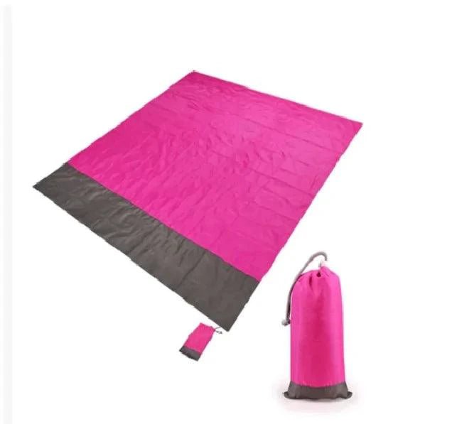 Mandotos sandproof portable beach mat spread on sandy shore, lightweight and foldable for convenient beach outings.