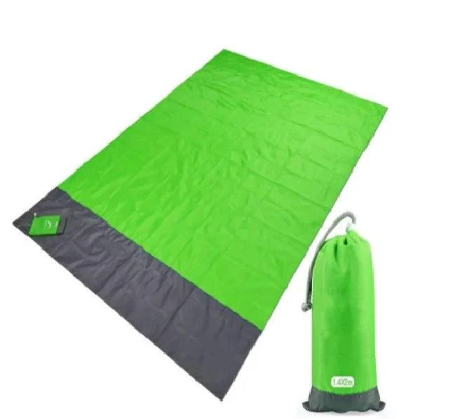 Mandotos sandproof portable beach mat laid out on sandy shore, lightweight and easy to carry for outdoor beach relaxation.