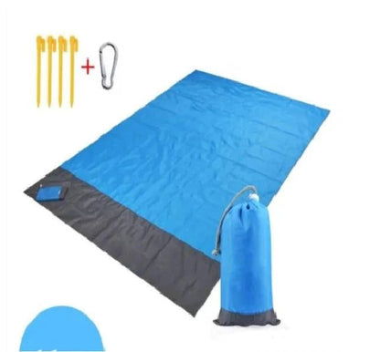 Mandotos sandproof portable beach mat laid out on sandy shore, lightweight and foldable for easy beach trips.