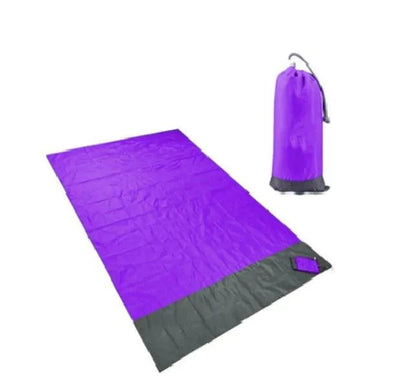 Mandotos sandproof portable beach mat spread on sandy shore, lightweight and easy to carry outdoor beach accessory