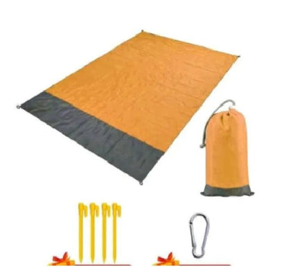 Mandotos sandproof portable beach mat spread on sandy shore, lightweight and easy to carry for outdoor beach use.