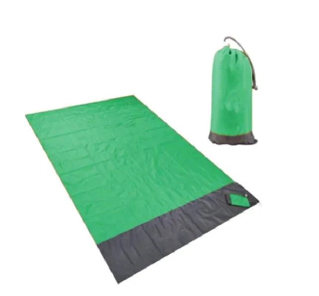 Mandotos sandproof portable beach mat spread on sandy shore, lightweight and easy to carry for beach outings.