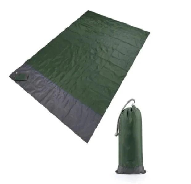 Mandotos sandproof portable beach mat spread out on sandy shore, lightweight and ideal for relaxing at the beach