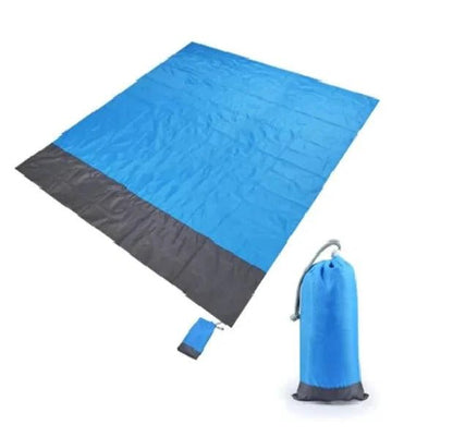 Mandotos sandproof portable beach mat spread on sandy shore, lightweight and easy to carry for outdoor beach relaxation.