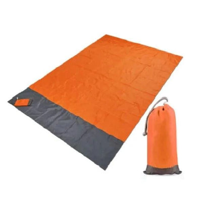 Mandotos sandproof portable beach mat spread out on sandy shore, lightweight and ideal for relaxing at the beach