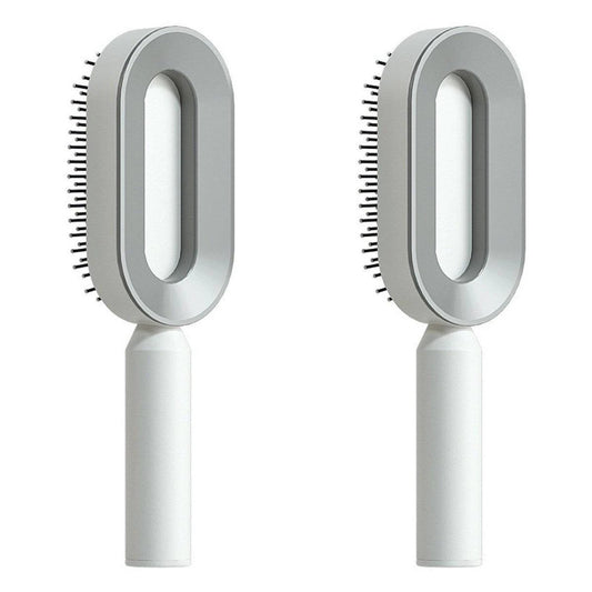 Mandotos self-cleaning hair brush with scalp massage features, showing the brush's bristles and ergonomic handle.