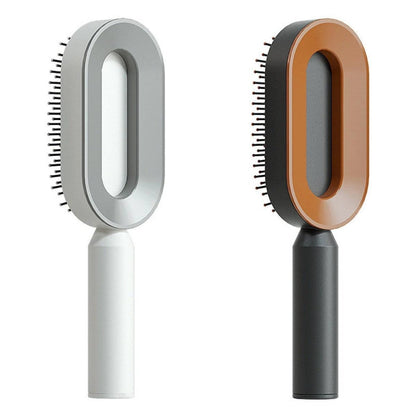 Mandotos self-cleaning hair brush with scalp massage feature and one-click cleaning, showing the ergonomic handle and bristles.