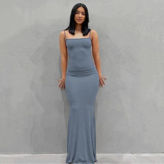 Mandotos sleek satin backless gown featuring a smooth, shiny fabric and elegant design, perfect for formal events.