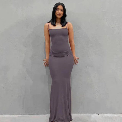 Elegant black satin backless gown by MANDOTOS, featuring a sleek design and flowing fabric for formal occasions.