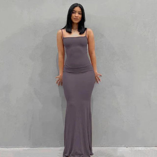 Elegant black satin backless gown by MANDOTOS, featuring a sleek design and flowing fabric, perfect for formal occasions.
