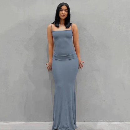 Elegant black satin backless gown by MANDOTOS, featuring a sleek design and flowing fabric for formal occasions.