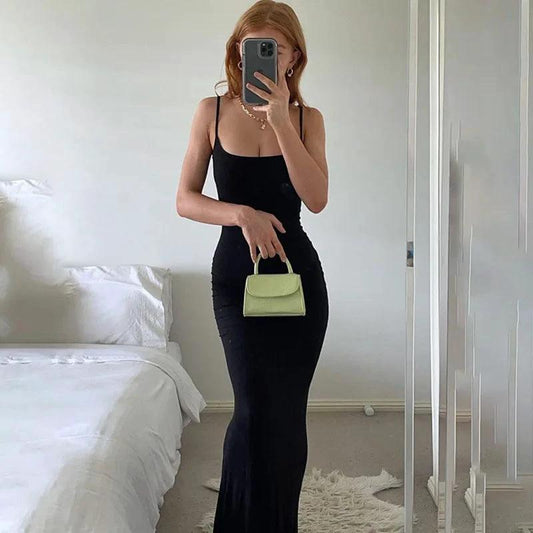 Mandotos sleek satin backless gown shown in a flowing, elegant design with smooth fabric and a low back style.
