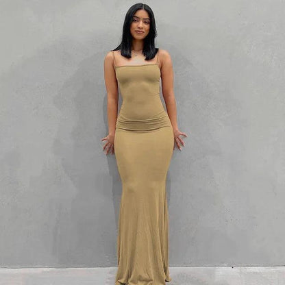 Close-up of MANDOTOS sleek satin backless gown, showcasing smooth fabric and elegant design on a model.