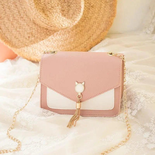Small MANDOTOS women's crossbody bag with cat lock chain, stylish messenger bag with adjustable strap and compact design.