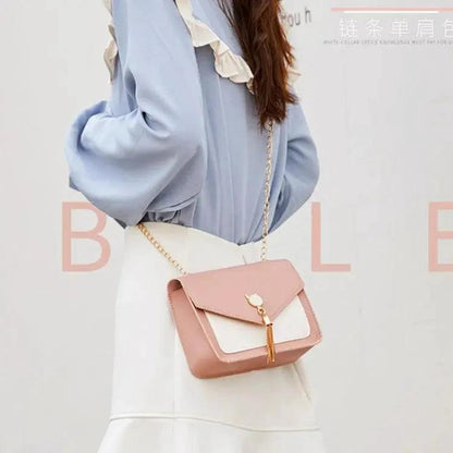 Small women's crossbody bag by MANDOTOS with a cat lock chain design and adjustable strap for casual and stylish wear.
