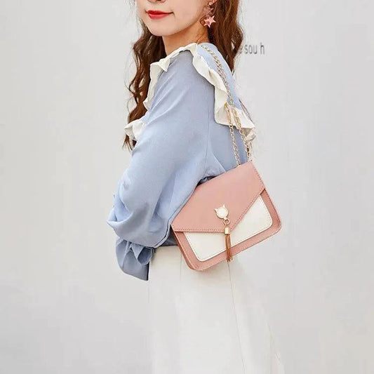 Mandotos small women’s crossbody bag with cat lock chain and messenger style, black faux leather accessory.