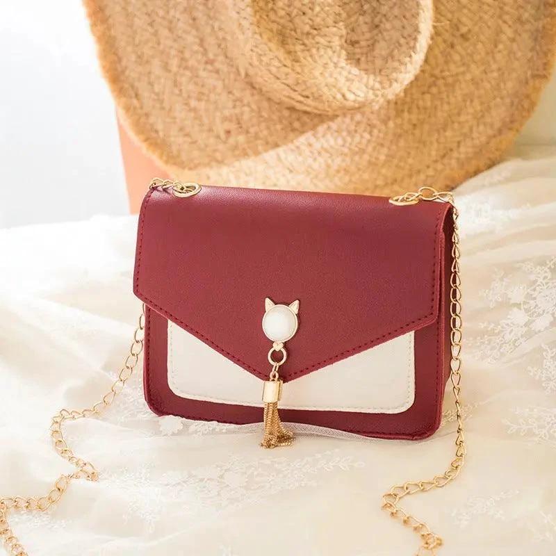 Small MANDOTOS women's crossbody bag with cat lock chain and messenger style, compact and stylish for everyday use.