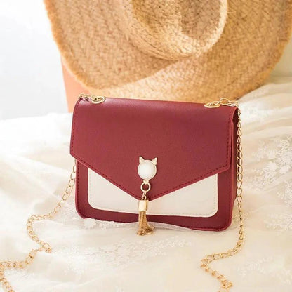 Small MANDOTOS women's crossbody bag with cat lock chain and messenger style, compact and stylish for everyday use.
