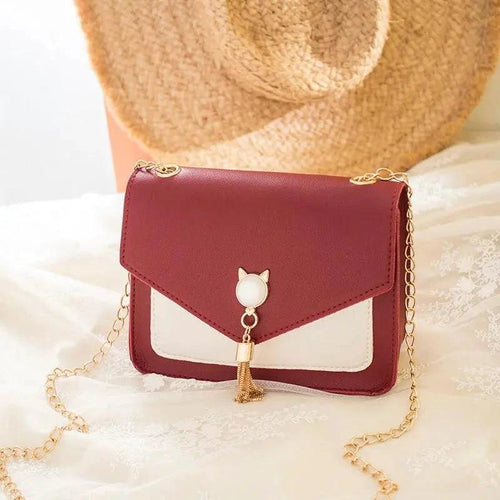 Small MANDOTOS women's crossbody bag with cat lock chain and messenger style, compact and stylish for everyday use.