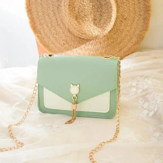 Mandotos small women's crossbody bag with cat lock chain and messenger style, stylish and compact for everyday use.