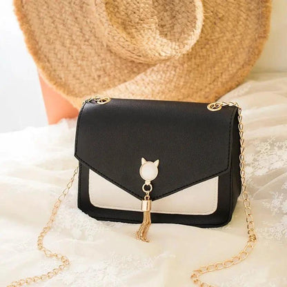Small MANDOTOS women's crossbody bag with cat lock chain, messenger style, black leather, compact and stylish for everyday use.